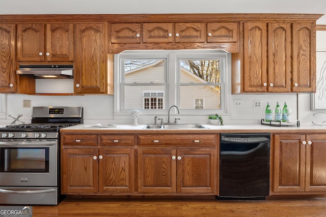 kitchen with dark wood-type flooring, sink, dishwasher, and gas stove