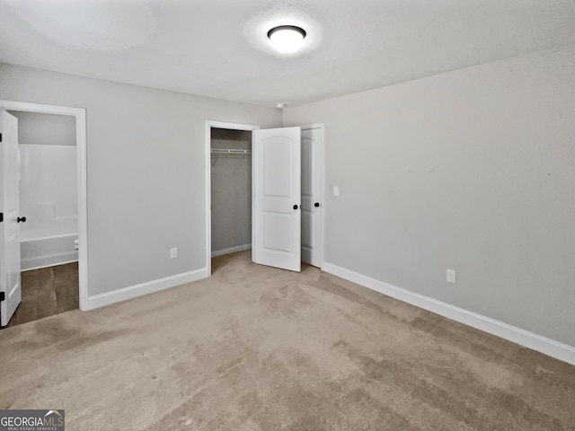 unfurnished bedroom with carpet floors and a closet