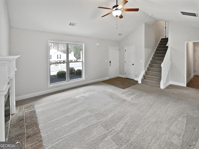 unfurnished living room featuring ceiling fan, a fireplace, carpet floors, and vaulted ceiling