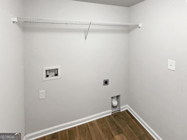 washroom with dark hardwood / wood-style flooring, washer hookup, and hookup for an electric dryer