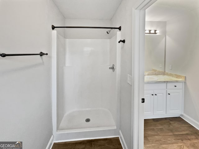 bathroom with a shower and vanity