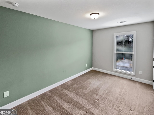 spare room featuring carpet floors