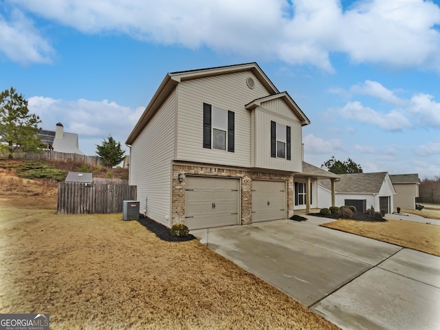 view of front of property featuring a garage and central air condition unit