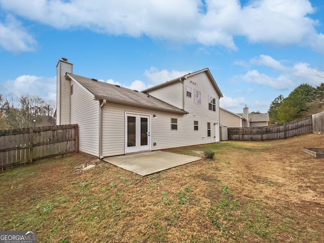 rear view of house with a yard and a patio