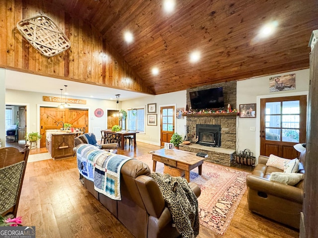 living room featuring wooden ceiling, high vaulted ceiling, and wood-type flooring