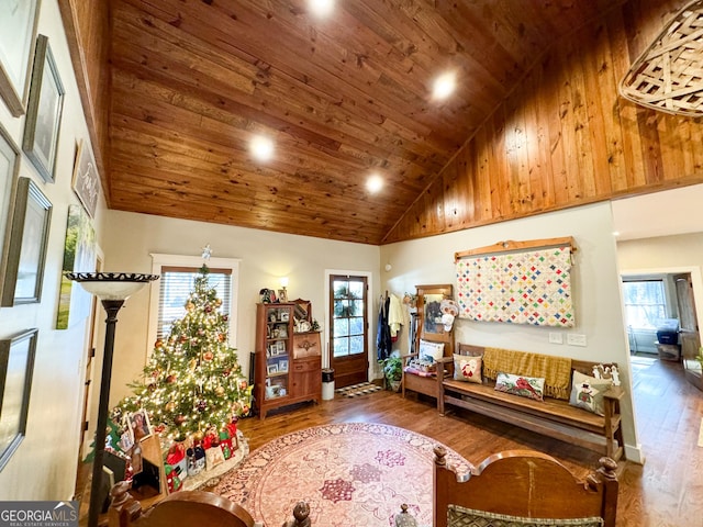 living room with hardwood / wood-style floors, high vaulted ceiling, and wooden ceiling