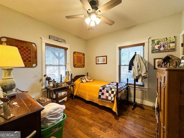 bedroom featuring multiple windows, ceiling fan, and dark hardwood / wood-style floors