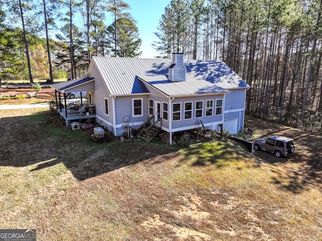 back of house with a yard and a garage