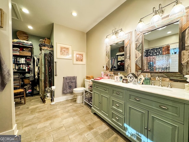 bathroom featuring a shower with curtain, vanity, and toilet