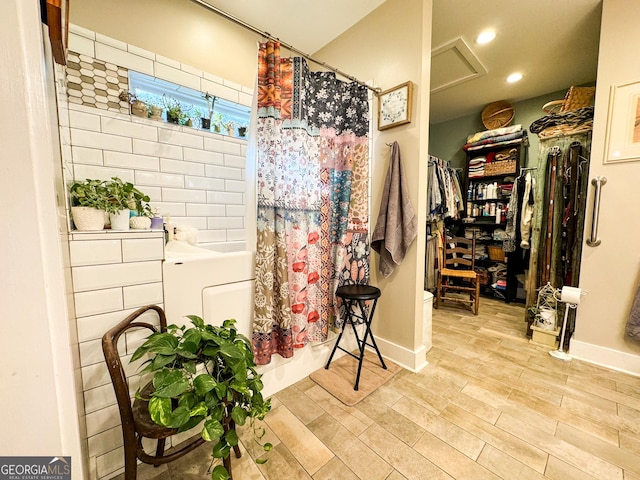 bathroom featuring hardwood / wood-style flooring and shower / tub combo with curtain