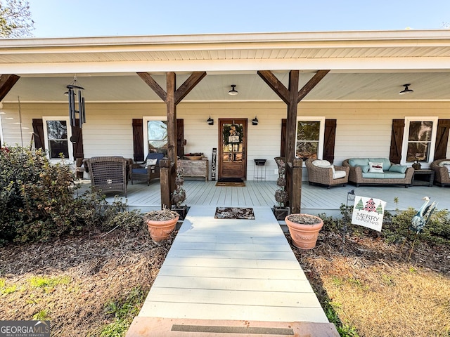 doorway to property with an outdoor living space and a porch