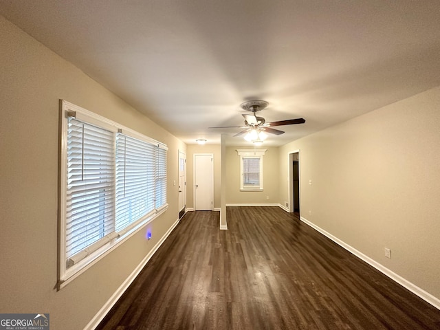 unfurnished room featuring ceiling fan and dark wood-type flooring