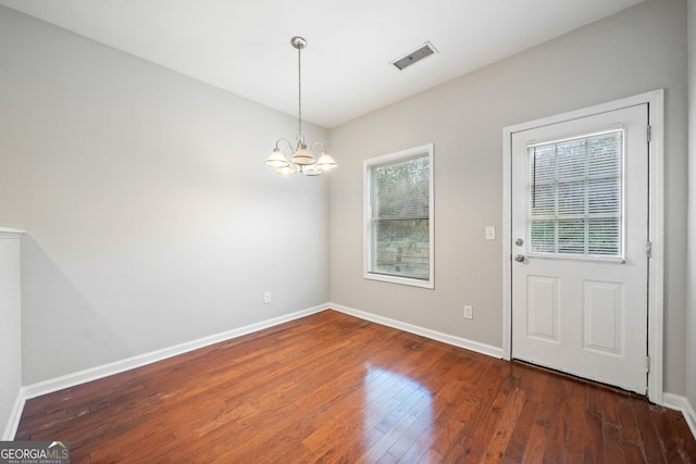 interior space featuring dark hardwood / wood-style flooring and a chandelier