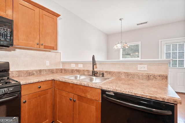 kitchen featuring hanging light fixtures, sink, black appliances, and a notable chandelier