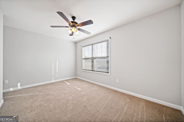 empty room featuring carpet flooring and ceiling fan