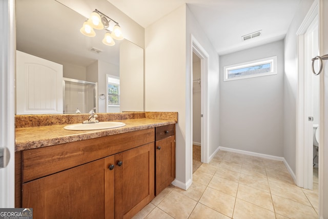 bathroom with tile patterned flooring, vanity, toilet, and an enclosed shower