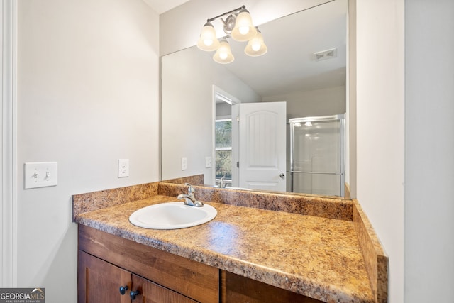 bathroom featuring vanity and an enclosed shower