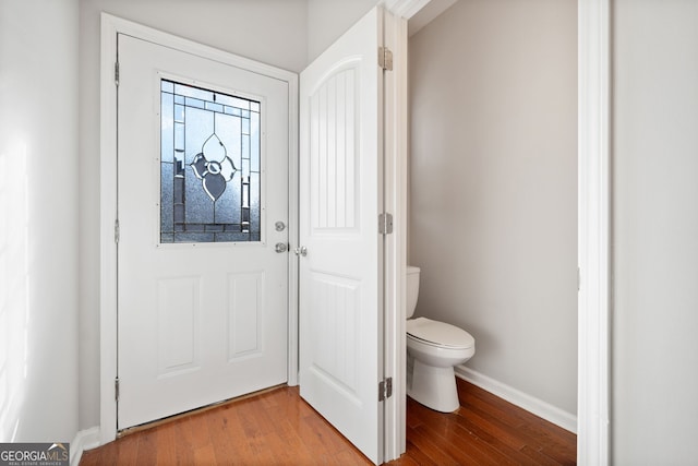 interior space with wood-type flooring and toilet