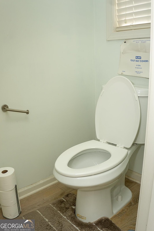 bathroom featuring hardwood / wood-style flooring and toilet