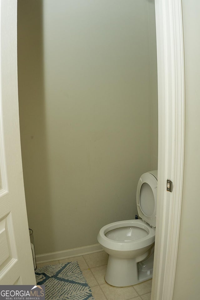 bathroom with toilet and tile patterned floors