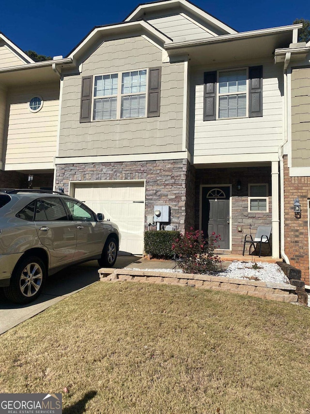 view of front of home with a garage and a front lawn