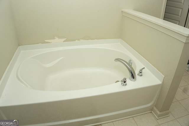 bathroom with tile patterned floors and a washtub