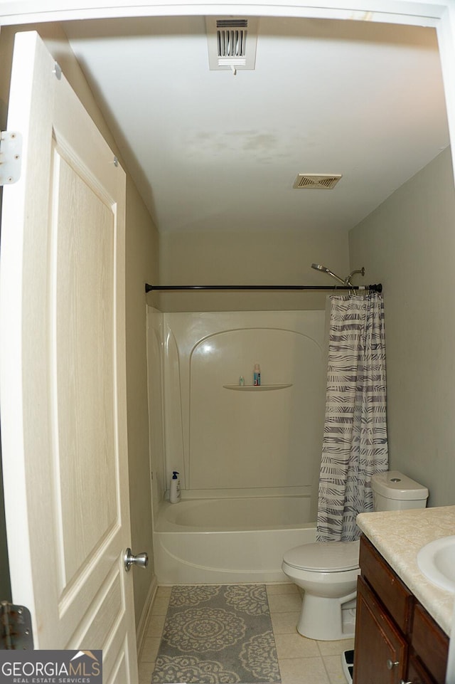 full bathroom featuring tile patterned floors, shower / bath combo with shower curtain, vanity, and toilet