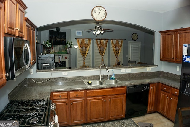 kitchen featuring sink, ceiling fan, black dishwasher, kitchen peninsula, and range with gas cooktop