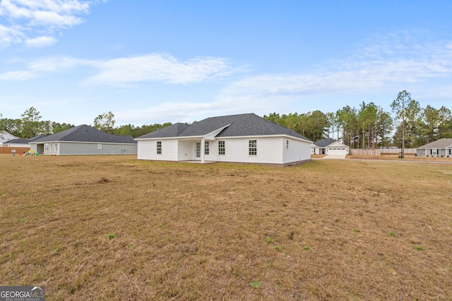 back of property featuring a lawn