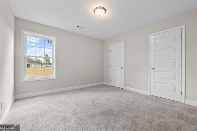 unfurnished bedroom with carpet flooring