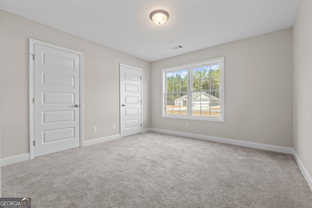 unfurnished bedroom with light colored carpet