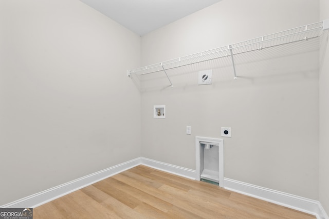 clothes washing area with hookup for a washing machine, hardwood / wood-style floors, and hookup for an electric dryer