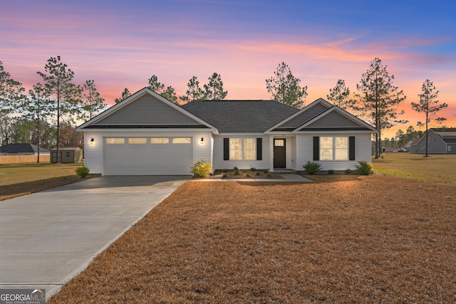 ranch-style house with a garage and a yard