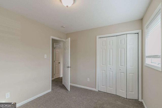 unfurnished bedroom with a closet, light carpet, and multiple windows