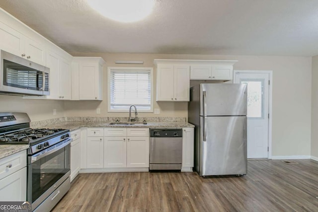 kitchen with white cabinets, a healthy amount of sunlight, sink, and appliances with stainless steel finishes