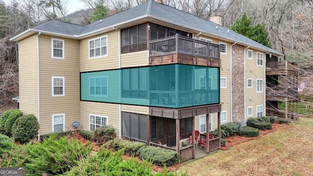 back of house featuring a sunroom and a patio