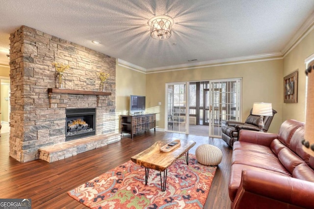 living room with a fireplace, a textured ceiling, hardwood / wood-style flooring, and ornamental molding