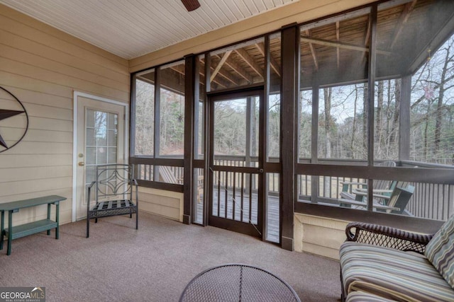 sunroom featuring ceiling fan and wood ceiling