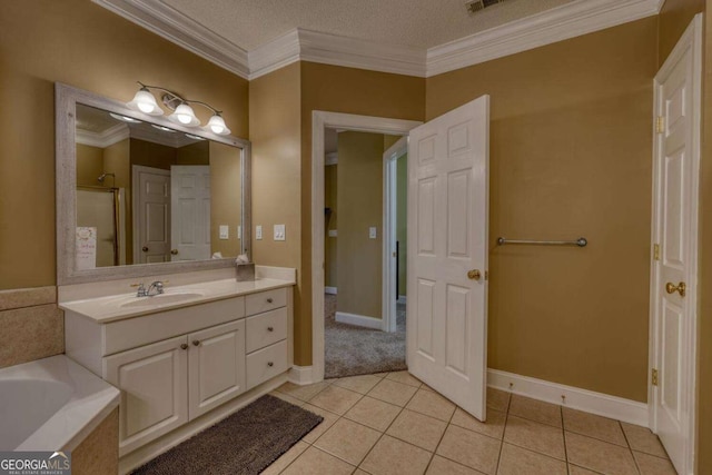 bathroom featuring vanity, tile patterned floors, ornamental molding, a tub to relax in, and a textured ceiling