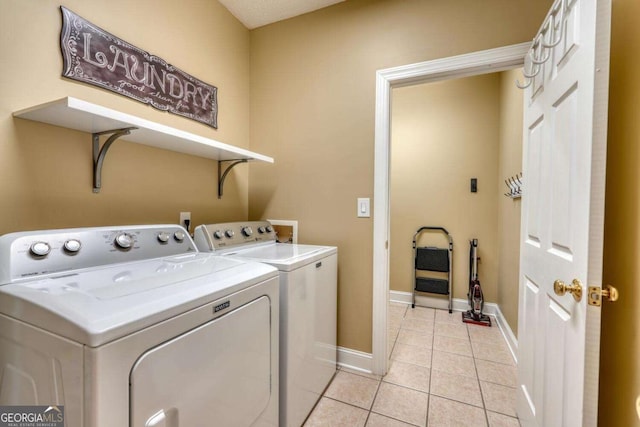 washroom featuring light tile patterned floors and washing machine and clothes dryer