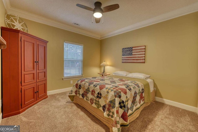 carpeted bedroom featuring ceiling fan, a textured ceiling, and ornamental molding