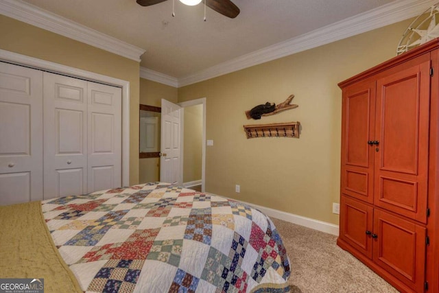 carpeted bedroom with ceiling fan, ornamental molding, and a closet