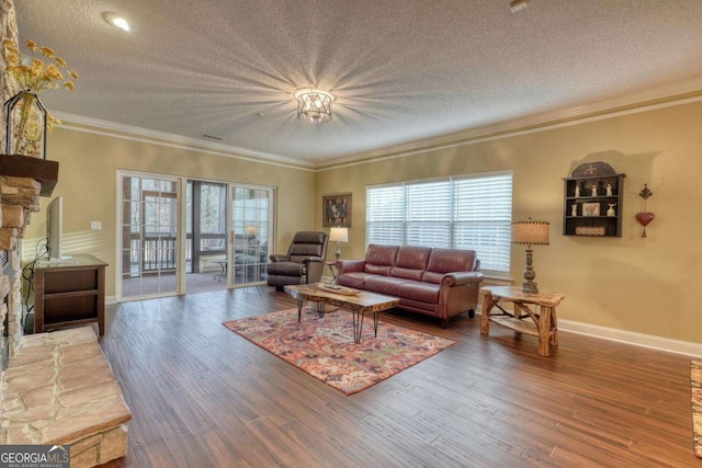 living room with a textured ceiling, hardwood / wood-style flooring, and a wealth of natural light