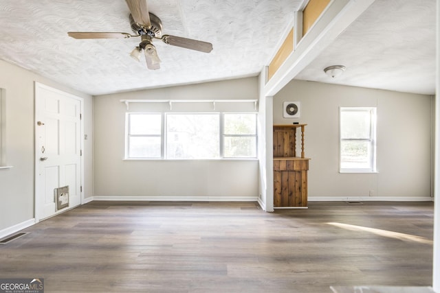 unfurnished living room featuring hardwood / wood-style flooring, ceiling fan, and lofted ceiling