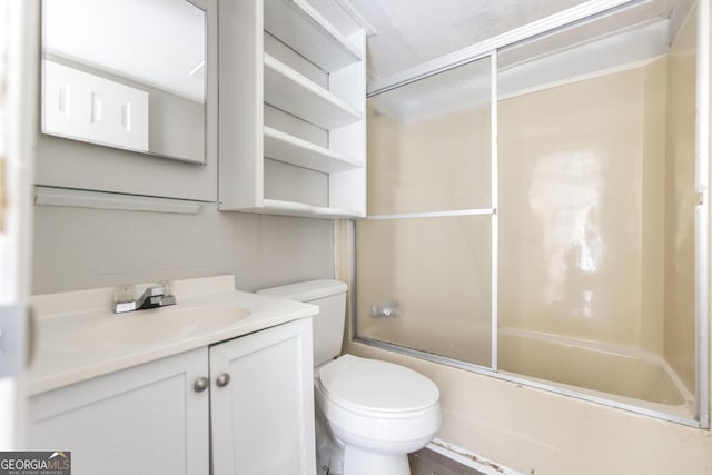 full bathroom featuring shower / bath combination with glass door, vanity, and toilet