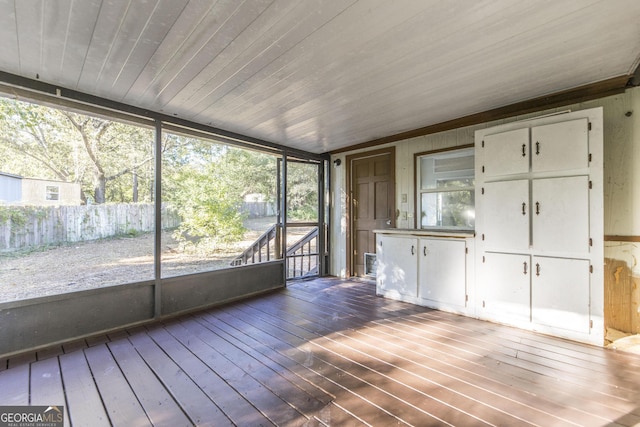 unfurnished sunroom with wooden ceiling