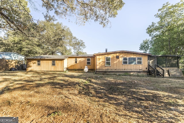 rear view of property with a sunroom