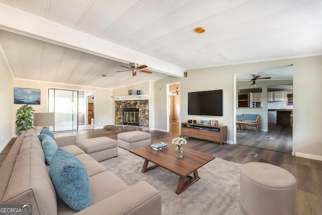 living room with hardwood / wood-style floors, lofted ceiling with beams, and a stone fireplace