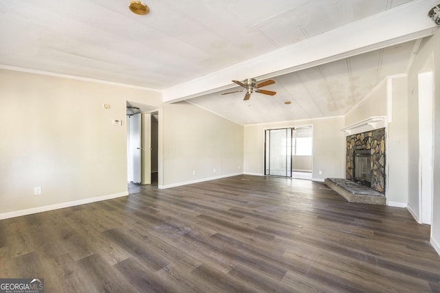 unfurnished living room featuring a stone fireplace, ceiling fan, dark hardwood / wood-style flooring, and lofted ceiling with beams