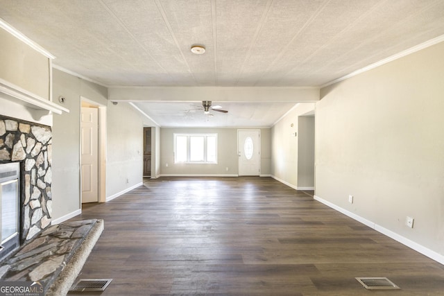 unfurnished living room featuring ornamental molding, a stone fireplace, ceiling fan, and dark wood-type flooring